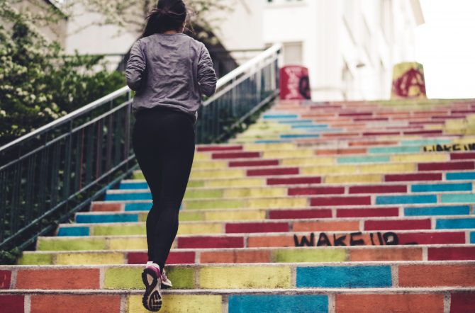 woman running up outdoor stairs