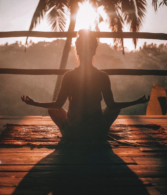 Meditating with sunset background