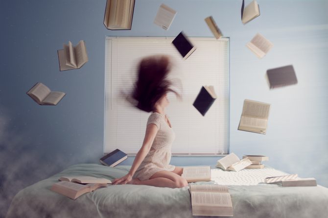 woman flipping her hair, books all around