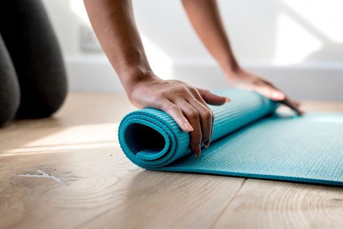 rolling up blue yoga mat