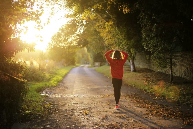 woman walking on pathway during daytime, exam stress