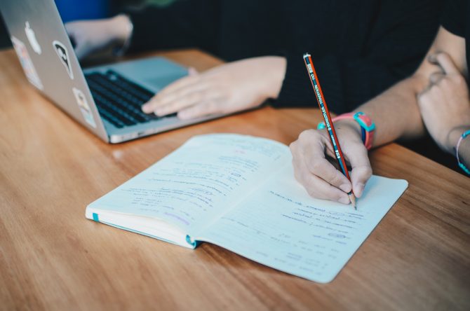 two people using macbook, writing