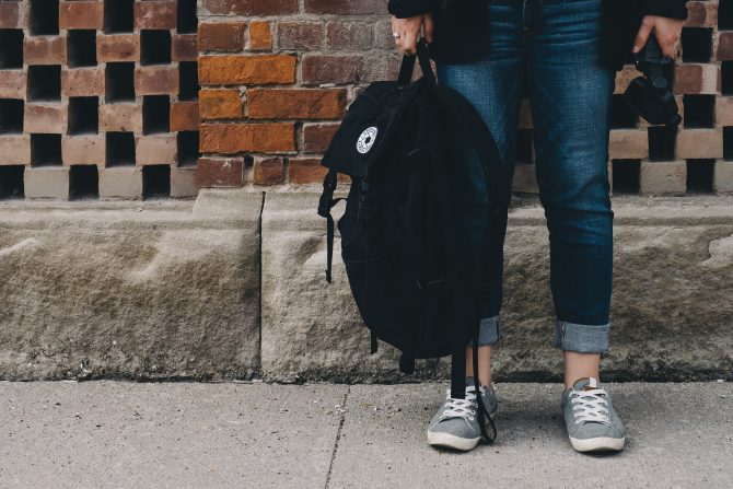 person holding backpack