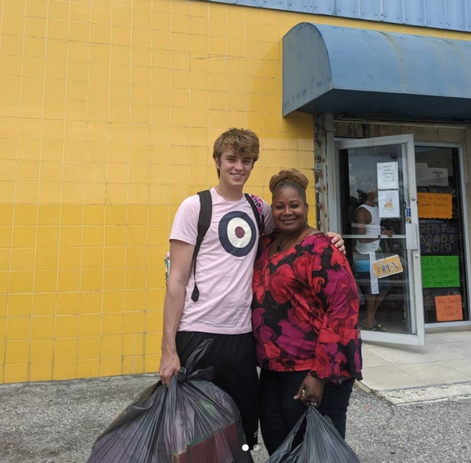 Nicholas holding a bag of necessities, Hurricane Dorian